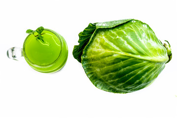 Naklejka premium Raw extracted Cucumber juice in a transparent glass isolated on white along with raw fresh cucumber and slices,also.