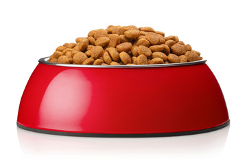 Dry cat food in a red bowl, isolated on white background