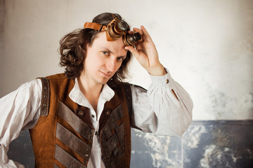 Steampunk pilot in a leather vest and flight glasses on his forehead.