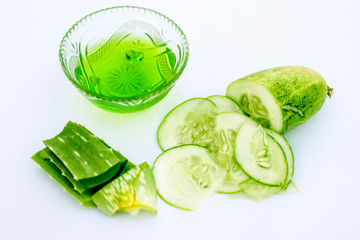 Raw cucumber along with some aloe vera gel well mixed in a glass bowl isolated on white entire ingredients.Used to rejuvenate your skin and for instant glow.