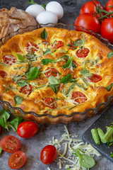 The Breakfast On Sunday Morning. Omelet in the oven with green beans, tomatoes, herbs and cheese. Food on dark background.