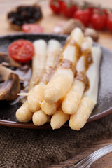 Asparagus cooked with homemade vinaigrette sauce on wood