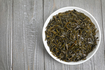 Fototapeta premium seaweed salad is a dietary product rich in iodine. on a grey wooden background.copy space