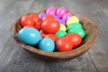 Multicoloured Easter eggs in a beautiful wooden bowl