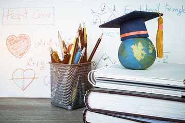 Education Graduate study concept: Graduation hat on pencils with formula arithmetic equation graph...