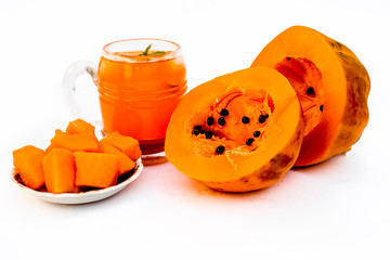 Papaya juice or smoothie isolated on white with entire ingredients which are honey,and ripe papaya.