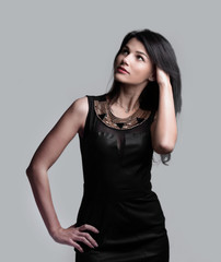 Naklejka premium modern young woman in black dress . isolated on grey
