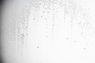 Obraz na płótnie Canvas white isolated background water drops on the glass / wet window glass with splashes and drops of water and lime, texture autumn background