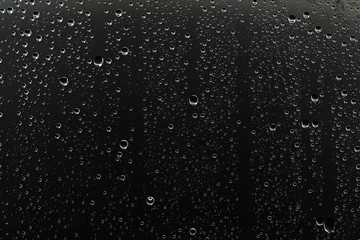black wet background / raindrops for overlaying on window, concept of autumn weather, background of drops of water rain on glass transparent