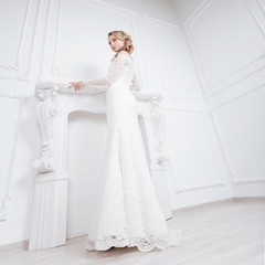 young woman trying on wonderful wedding dress