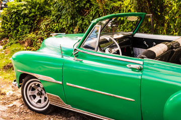 Havana, Cuba - 2019. Green classic American car on the streets of Havana, tourist attraction.