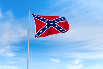 Confederate flag over blue sky background