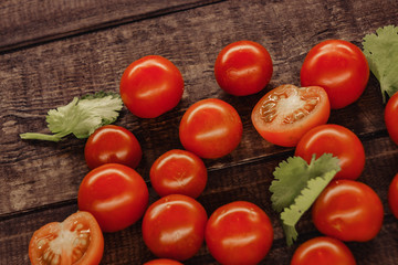 tasty cherry tomatoes on a wooden stand, wooden background