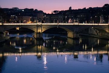 Fototapeta na wymiar Sunset on an ancient bridge of Rome, Italy, golden hour