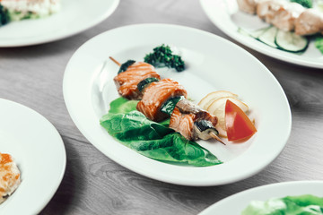barbecue on wooden skewers with fresh vegetables.