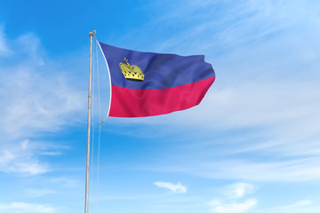 Naklejka na ściany i meble Liechtenstein flag over blue sky background