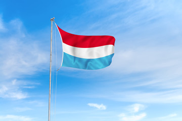Naklejka na ściany i meble Luxembourg flag over blue sky background
