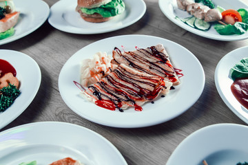 pancakes with syrup, fruit sauce and pineapple slices