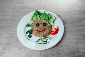 baby food. funny chicken cutlet with vegetables