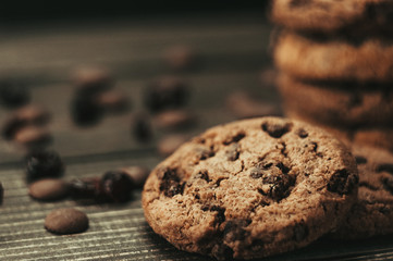 Stack of homemade chocolate chip cookies sitting in front of ingredients