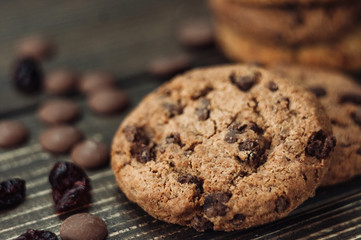 Stack of homemade chocolate chip cookies sitting in front of ingredients