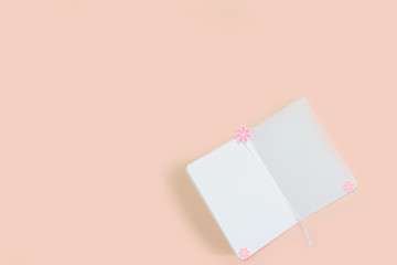 open notepad on a pink background