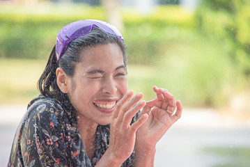 Asian woman play water in Songkran festival or Thai new year in Thailand.