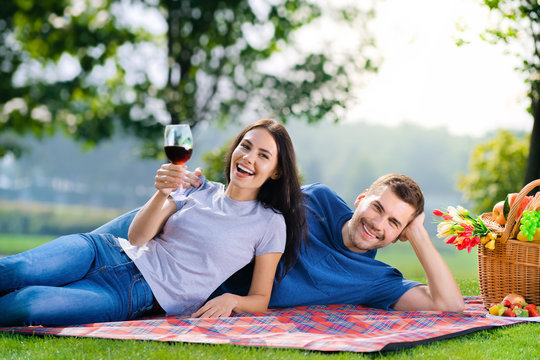 Young couple in love, lying together on a picnic