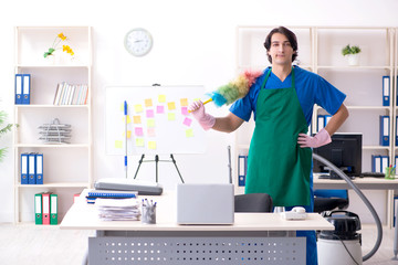 Male handsome professional cleaner working in the office 