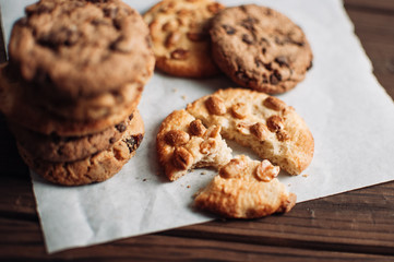 Crumbs from chocolate cookies on a wooden table background. Copyspace