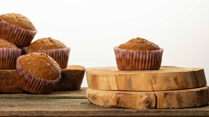 homemade muffins with coconut chips on a wooden stand