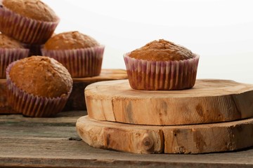 homemade muffins with coconut chips on a wooden stand