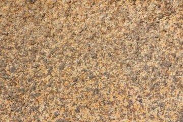 Texture of a yellow-gray granite stone