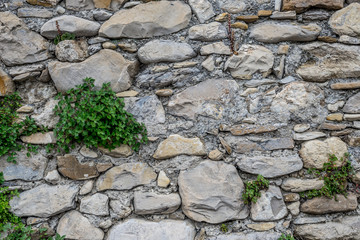 Detail view of an ancient stone wall in the village of Borgo Cervo in liguria Italy. Useful as a background.