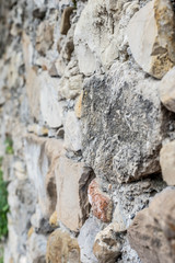 Detail view of an ancient stone wall in the village of Borgo Cervo in liguria Italy. Useful as a background.