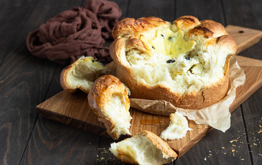Freshly brioche bread with cottage cheese and raisin filling. Traditional Romanian sweet yeast bread. Easter bread. Rustic style. 