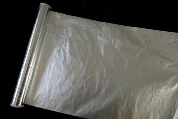 aluminum foil on black background, aluminum foil for baking