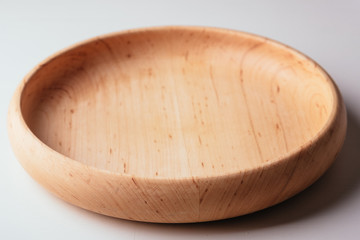 Wooden wood round plate on white background isolated