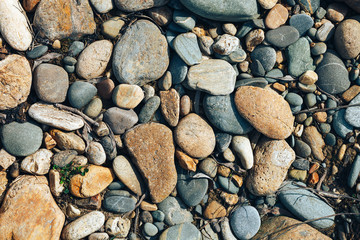 stone texture, top view Close up abstract background with dry round reeble pattern, have dry leaves with stones