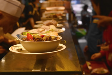 fried scallop and clam in bowl for serving on counter restaurant