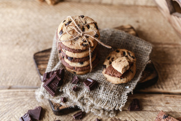 Chocolate cookies on wooden rustic table. Homemade cookies. Stack of tasty chocolate cookies