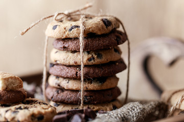 Chocolate cookies on wooden rustic table. Homemade cookies. Stack of tasty chocolate cookies