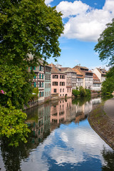 Fototapeta na wymiar Water canal on Grand Ile island in center of Strasbourg city, Alsace, France