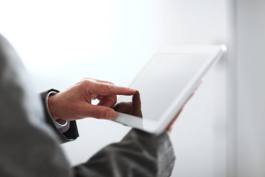 close up.blurred image businessman presses on the screen of a digital tablet.photo with copy space