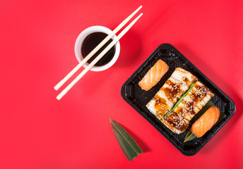 Sushi rolls set served on red background. Japanese food.