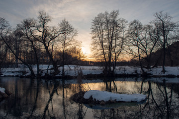 Winter landscape with river and sunset