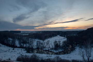 Winter landscape with river and sunset