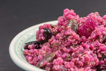 Obraz premium pink quinoa salad with beetroot and pumpkin seeds