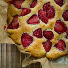 Top view close-up of a homemade strawberry cheesecake. Squared format.