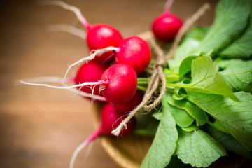 fresh organic red radish on a wooden table